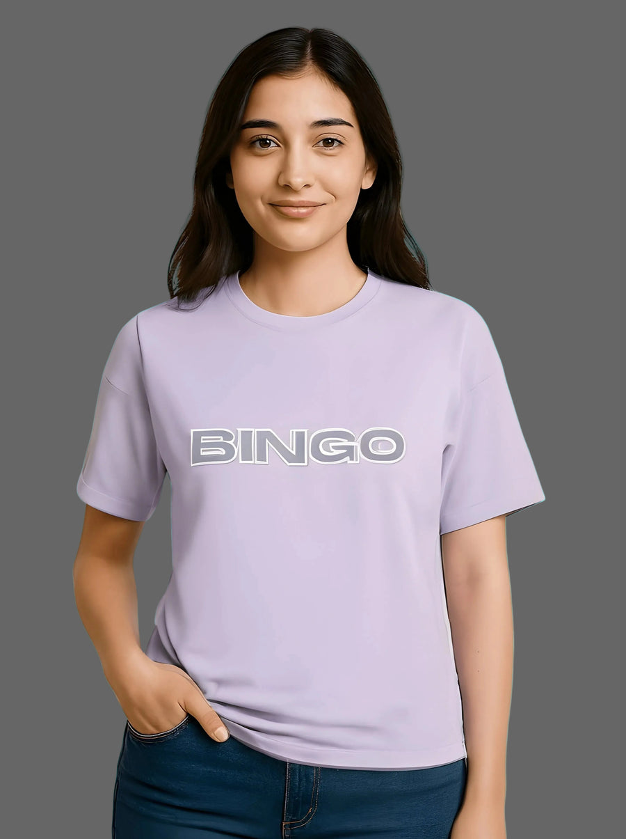 Person wearing a light purple t-shirt with 'BINGO' printed on it, standing against a lavender background.